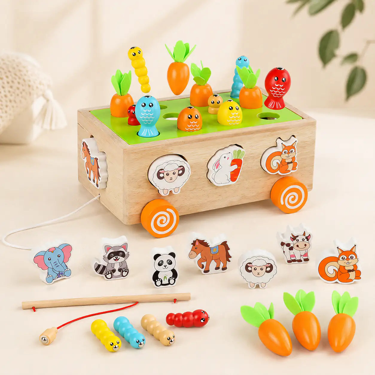 Wooden Montessori harvest cart with carrots, animal pieces and magnetic fishing rod on a cream background