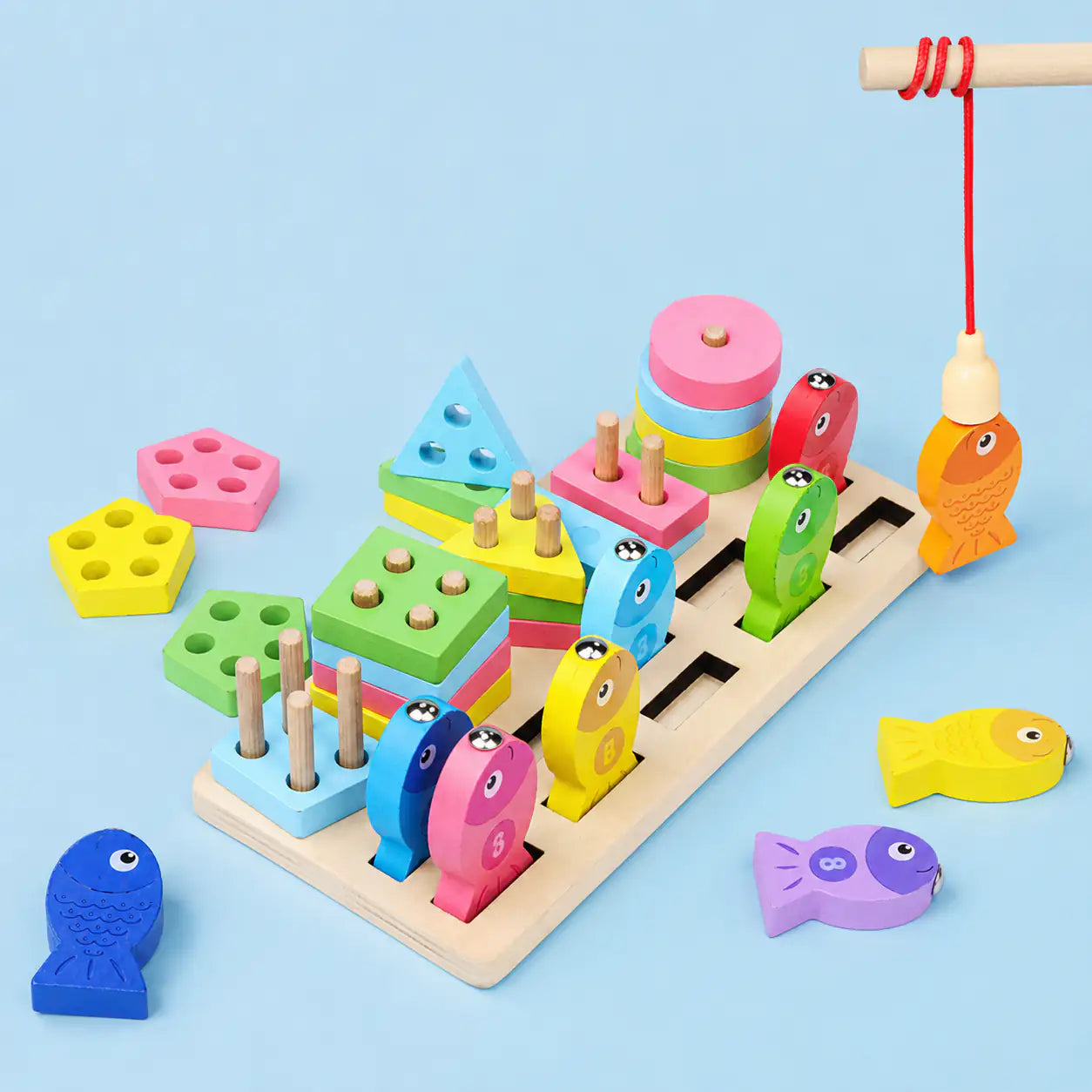 Close-up of the wooden geometric shape pieces, pegs and numbered fish slots on the activity board