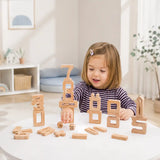 Tall sculptural tower of natural wood stacking number blocks 0 to 10 with math operator pieces and wooden dice arranged below