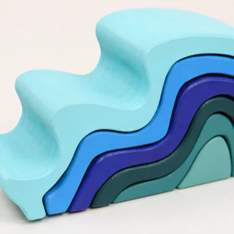 Side view of assembled wooden ocean wave stacker showing curved silhouette