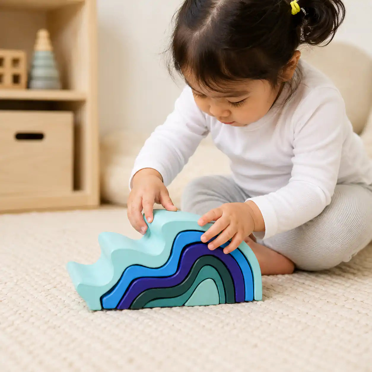 Wooden ocean wave stacker beside a ruler and tape measure showing size and scale