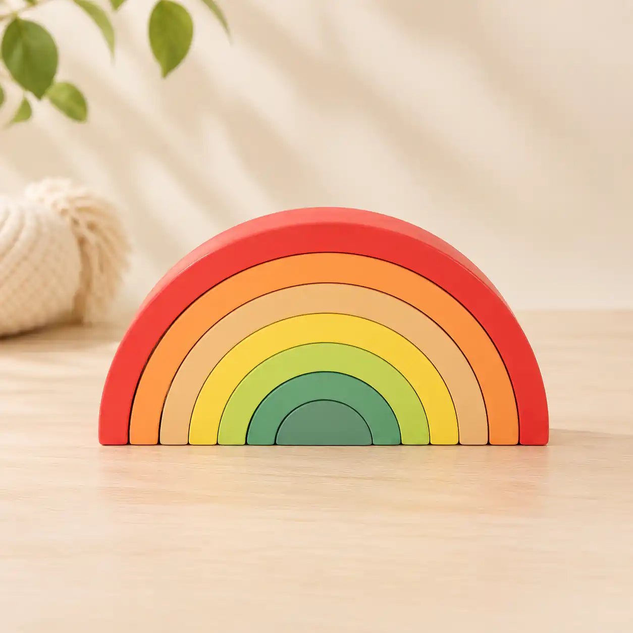 Wooden pull-along xylophone with 7 colorful metal bars, wooden mallet, yellow pull string, and dark wood base on wheels