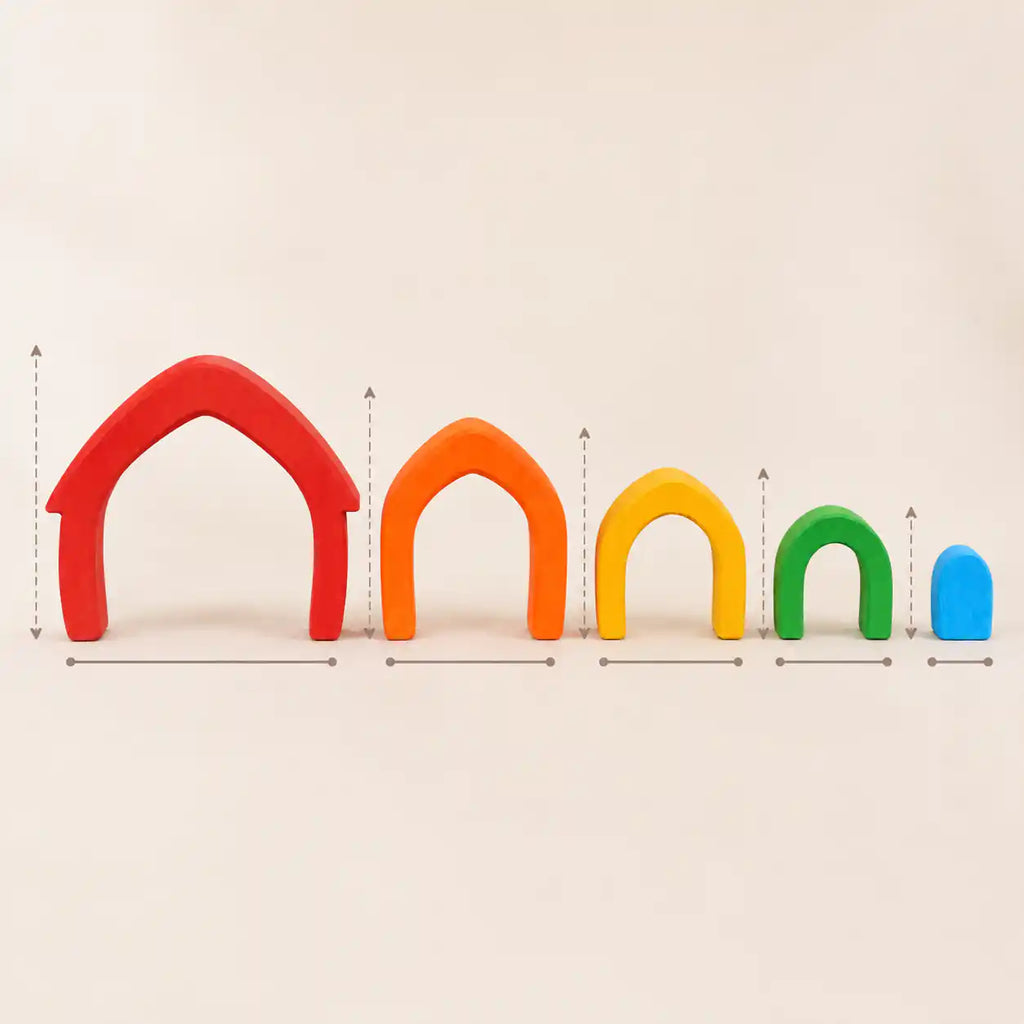 Wooden rainbow arches arranged separately on a cream surface showing each color in the set