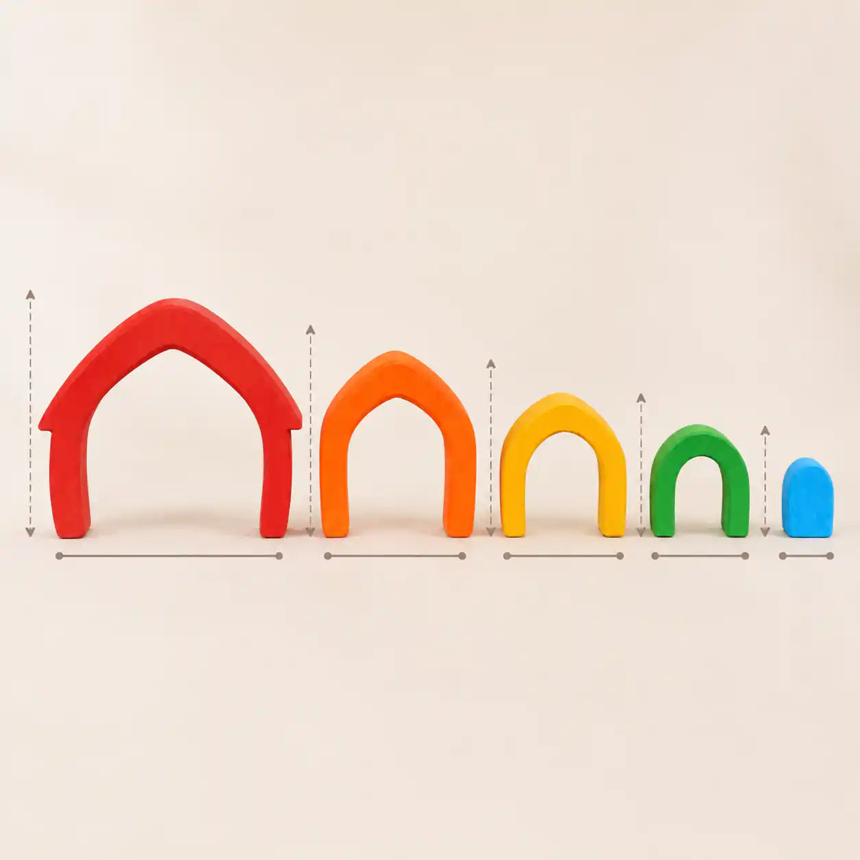 Wooden rainbow arches arranged separately on a cream surface showing each color in the set