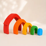 Side angle of wooden rainbow arch stacker showing graduated arch sizes and rainbow color order