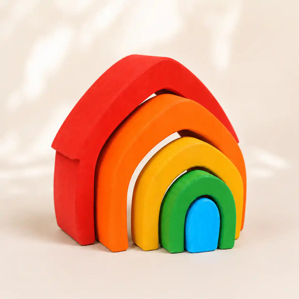 Wooden rainbow arch stacker styled in a warm nursery play scene