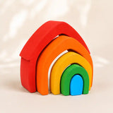 Wooden rainbow arch stacker styled in a warm nursery play scene