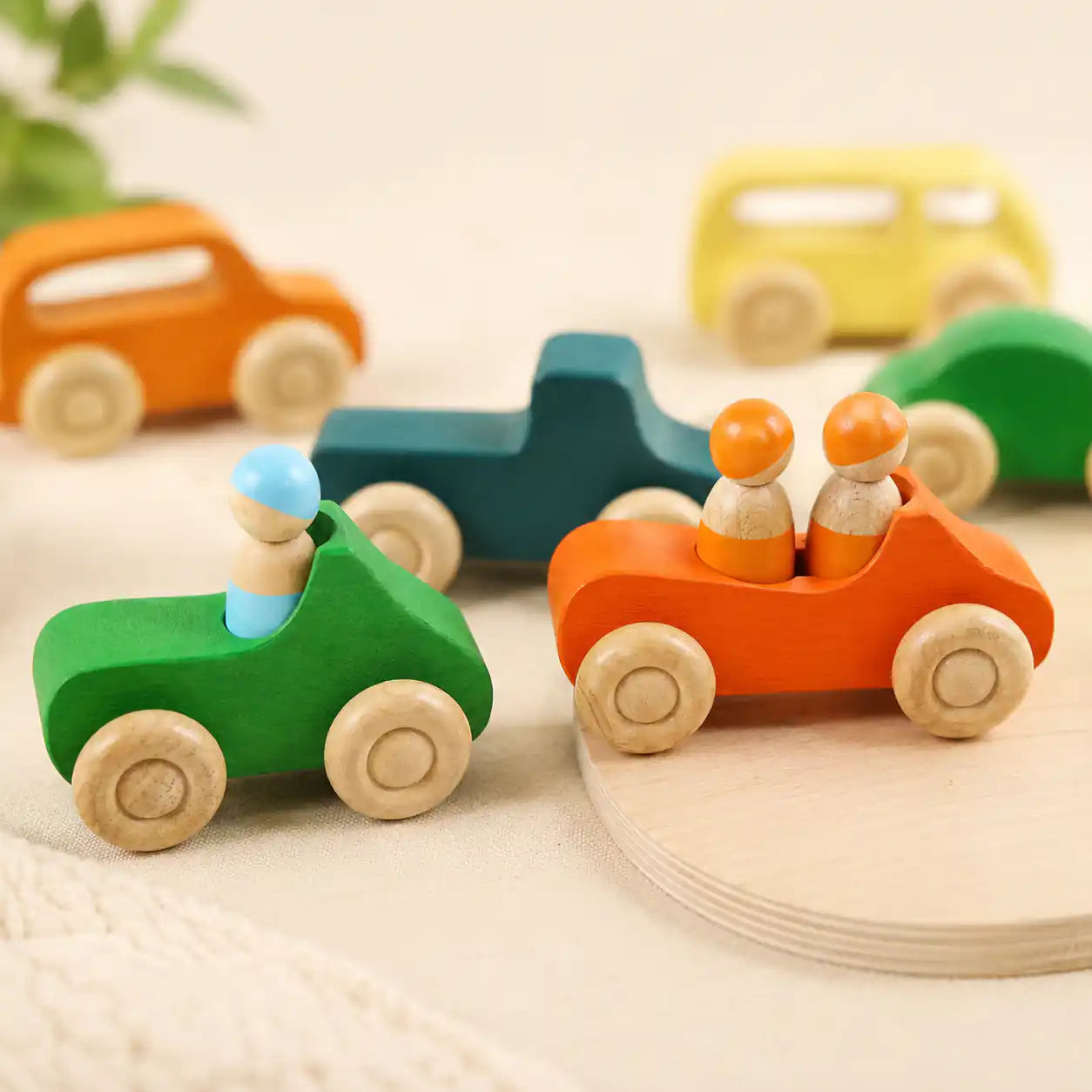 Close-up of wooden rainbow peg dolls showing painted faces and smooth finish