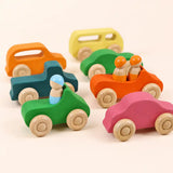 Side view of wooden rainbow car showing peg dolls seated and rolling wheels