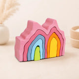 Wooden rainbow coral stacker partially stacked showing each colorful layer