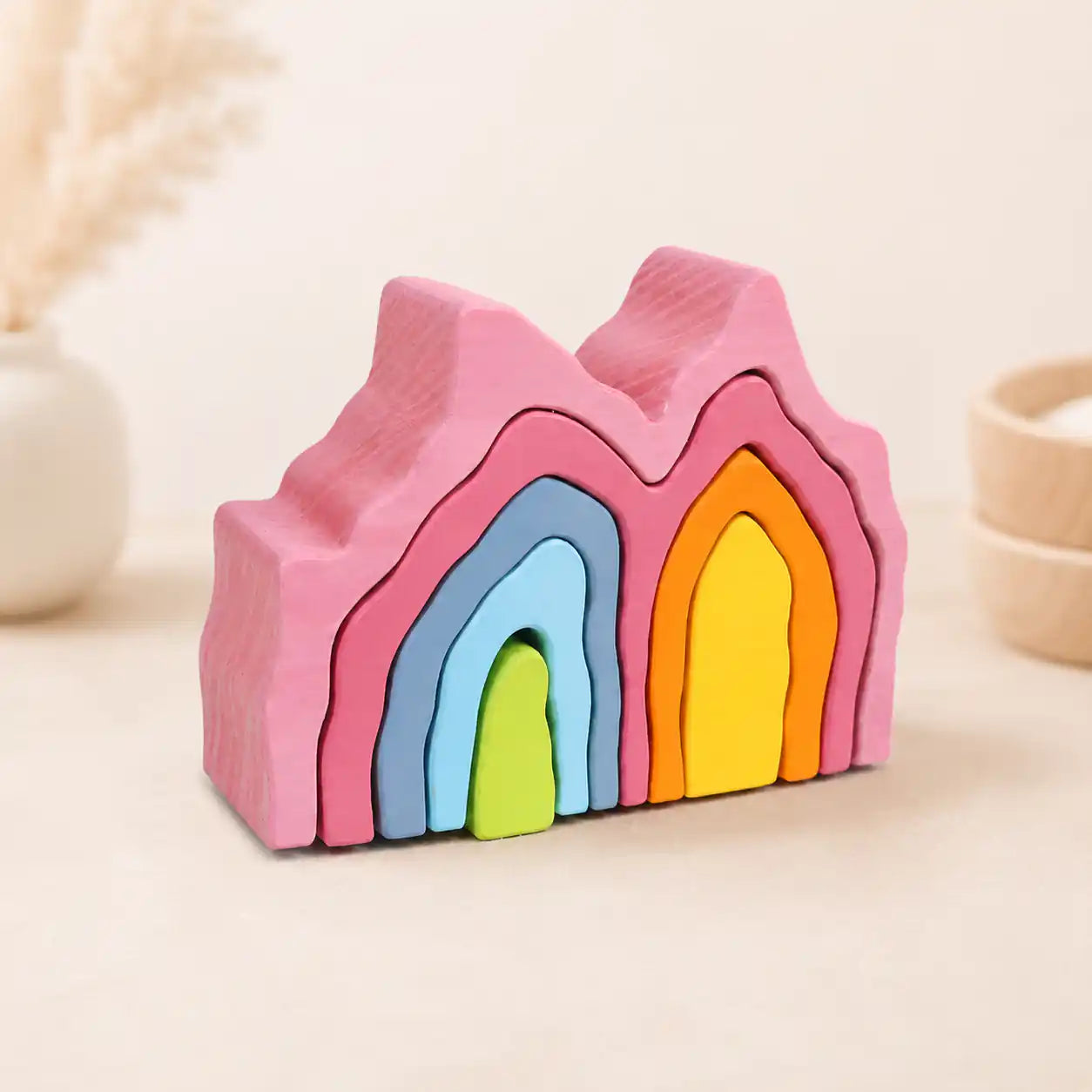 Wooden rainbow coral stacker partially stacked showing each colorful layer