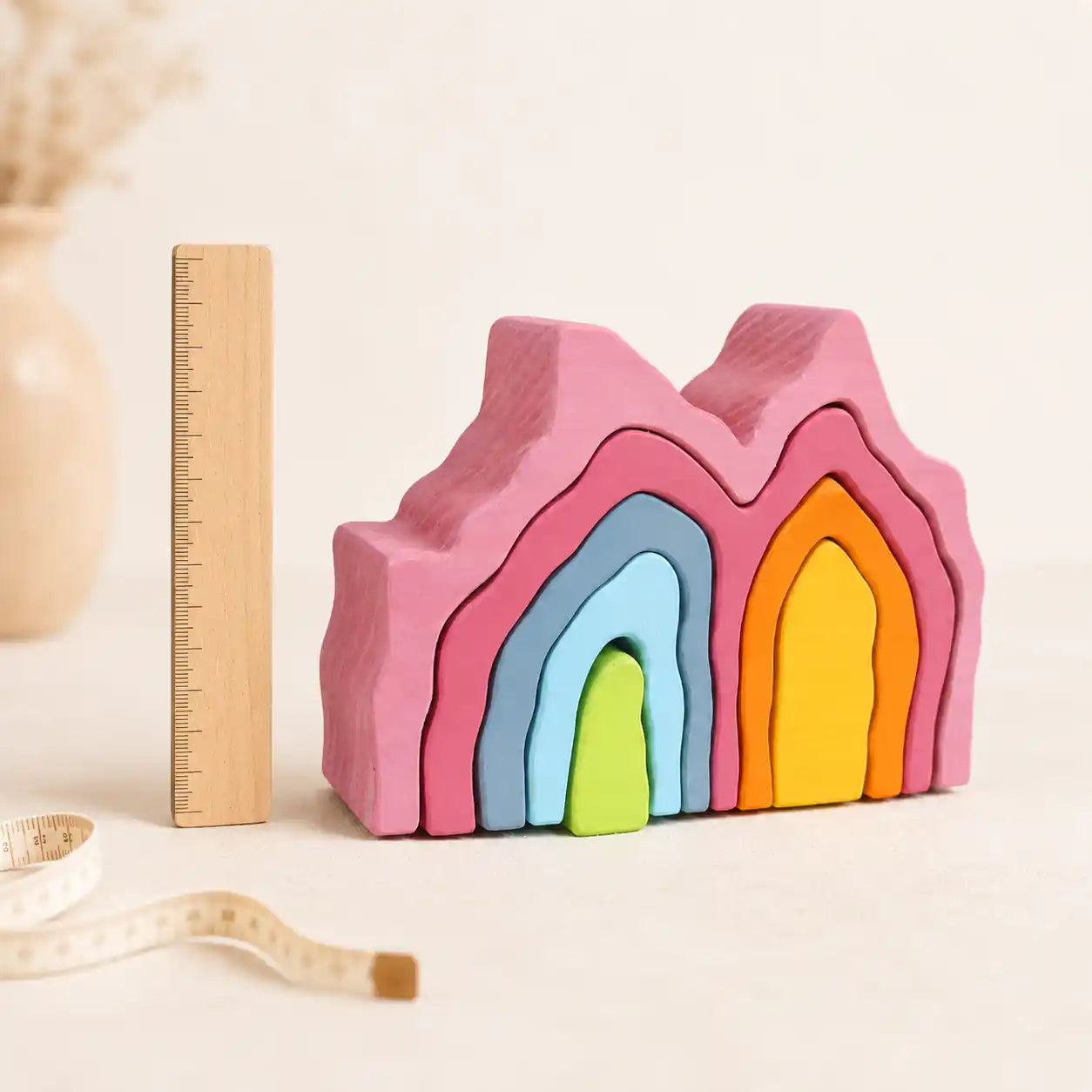 Close-up of a single wooden coral stacker piece showing painted finish and detail