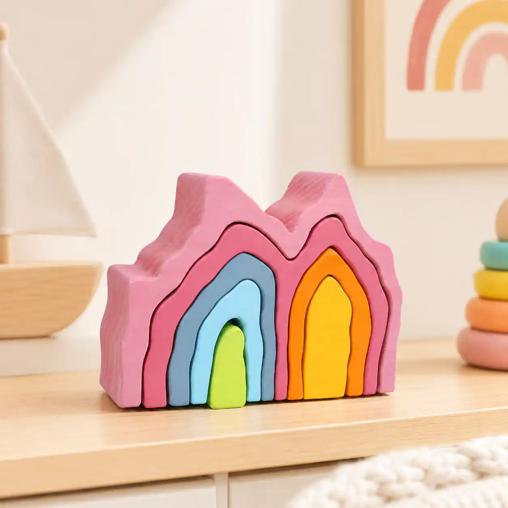 Wooden rainbow coral stacker styled in a warm nursery play scene