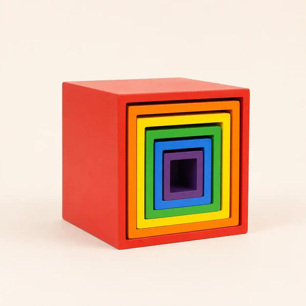 Wooden rainbow nesting cubes arranged in a graduated row showing each size and color