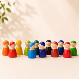 Wooden rainbow peg doll friends arranged in a circle showing each painted face