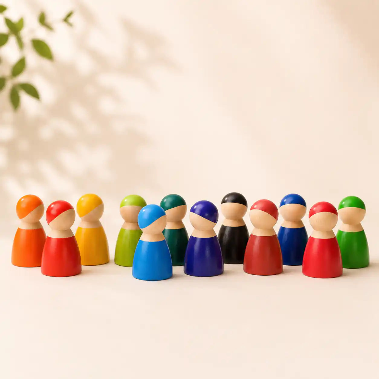 Wooden rainbow peg doll friends arranged in a circle showing each painted face