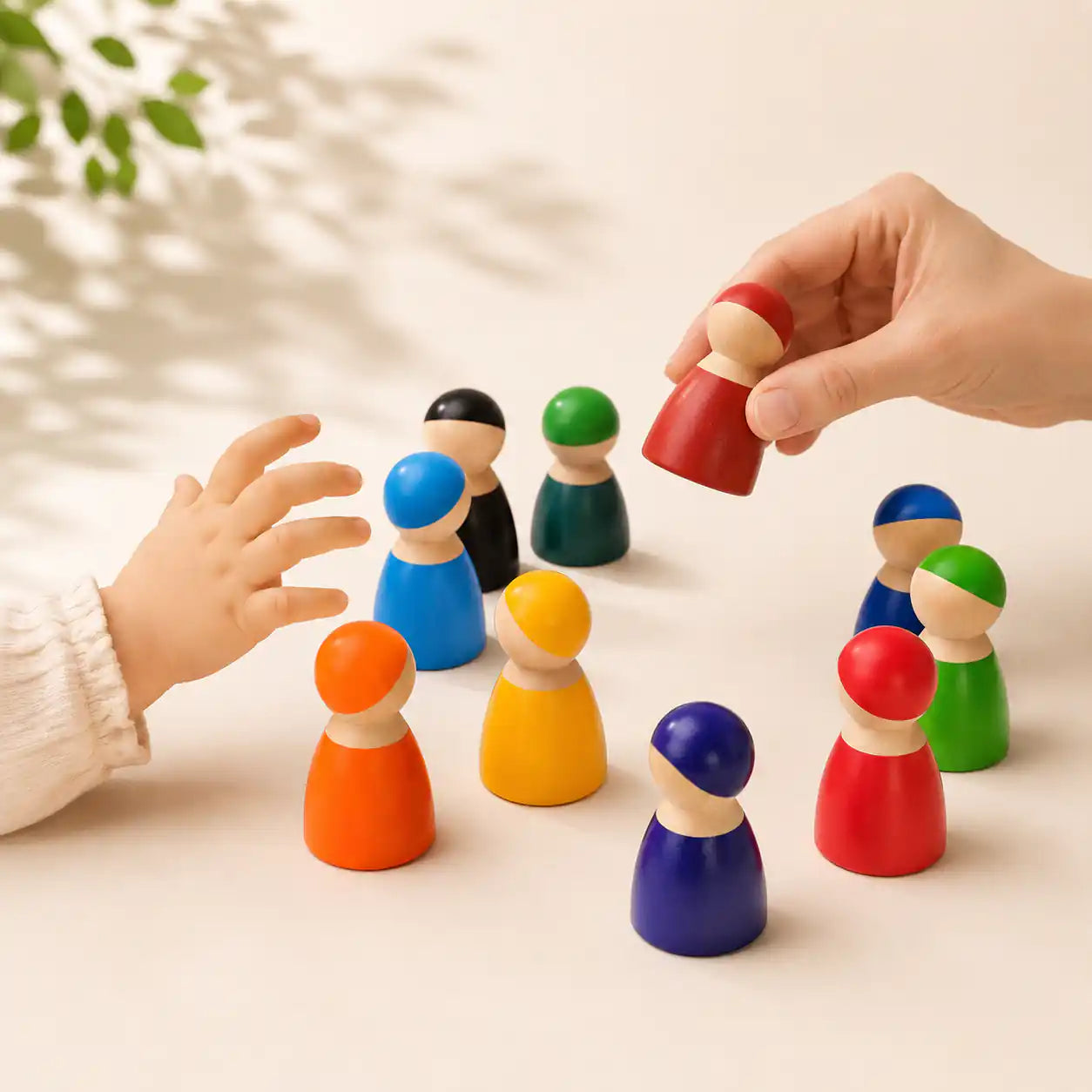 Close-up of wooden rainbow peg doll faces showing painted detail and smooth finish