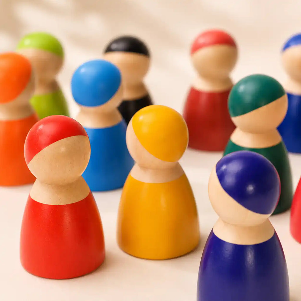 Wooden rainbow peg doll friends grouped together in an imaginative play scene