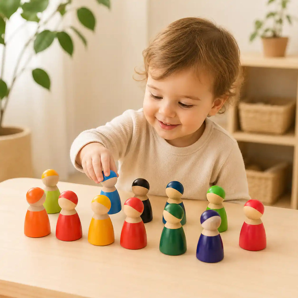 Wooden rainbow peg doll friends beside a ruler showing size and scale