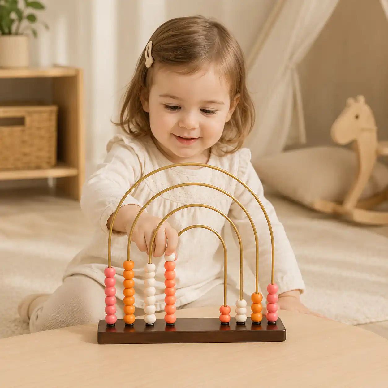 Wooden rainbow puzzle with 7 nested colorful arches in red, orange, yellow, light green, green, and dark green on a wooden tabletop