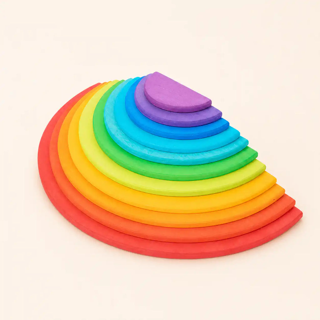 11-piece wooden Waldorf rainbow semicircles nested from largest red to smallest purple in graduated sizes