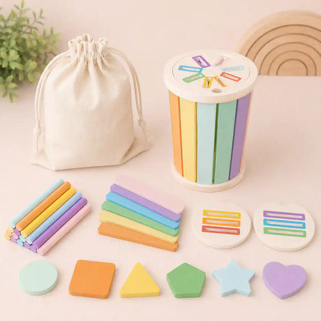 Pastel wooden Montessori sorting cylinder set with shape pieces and colored sticks styled on a soft neutral surface