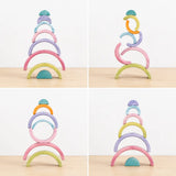 Macaron pastel rainbow stacker pieces balanced into a stacked tower showing fine motor and stacking play