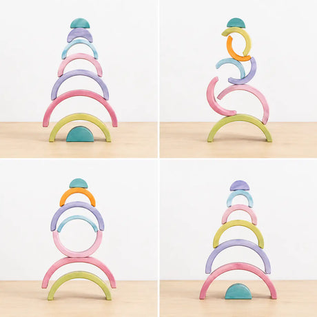Macaron pastel rainbow stacker pieces balanced into a stacked tower showing fine motor and stacking play