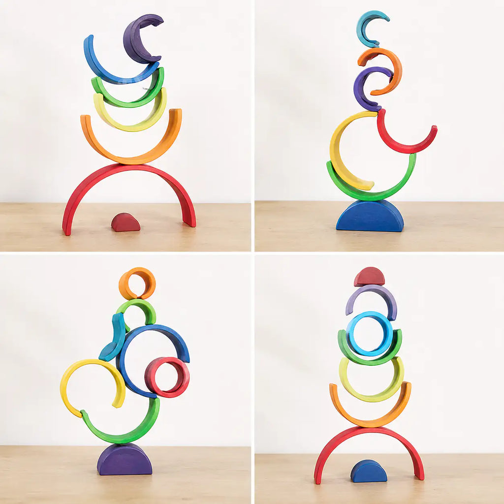 Rainbow stacker pieces balanced into a stacked tower showing fine motor and stacking play