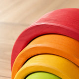Close-up of the smooth matte finish and sanded wood grain on a rainbow stacker arch piece