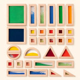 Wooden sensory blocks stacked into a Montessori tower on cream background