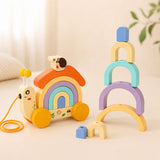 Close-up details of wooden snail pull toy — antennae, snail topper, pastel rainbow arches, and wooden wheels
