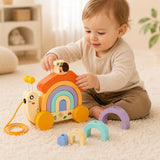 Toddler crawling on a soft rug while pulling the wooden snail pull-along toy by its string