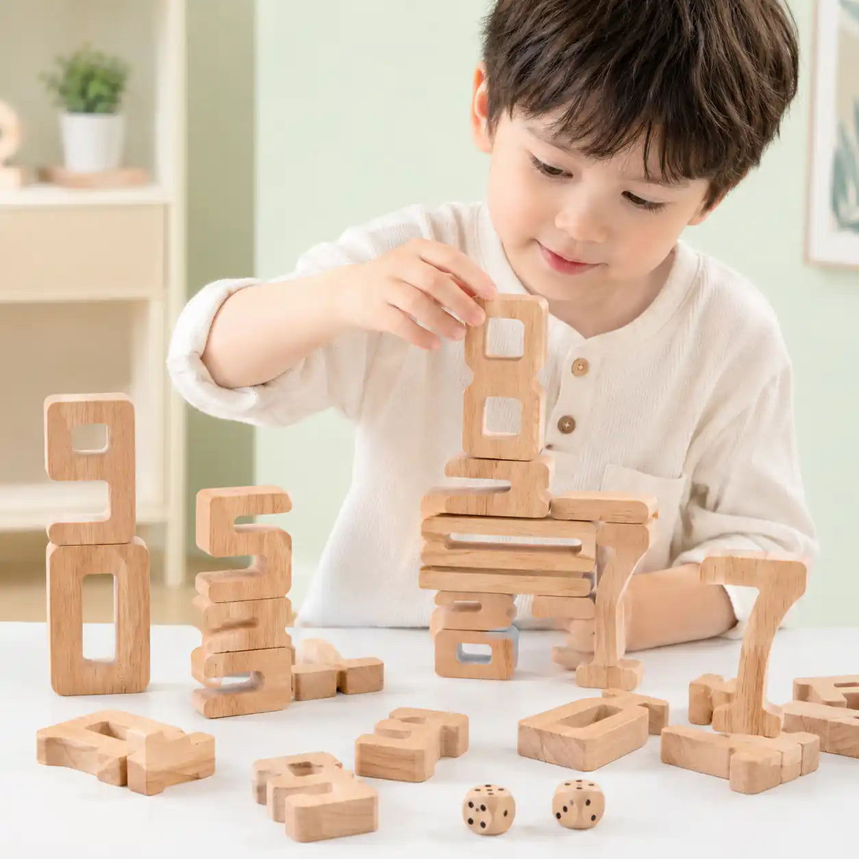 Natural wood stacking number blocks 0 to 10 arranged with math operator pieces and dice on a soft blue Montessori display