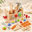 Wooden toddler tool box with pretend tools, gears, nuts and bolts on a cream background